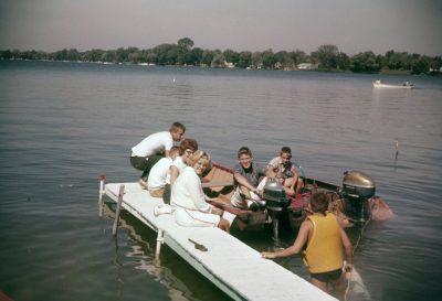Mike Ligibel, about the time of the infamous VW ride. Also on dock, Jane Dianich.  Rick Belcher is in the boat with the Mercury outboard.