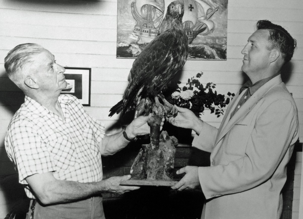 The ceremonial passing of the stuffed eagle from Rollo Every to Cal Pittman at the time when PIttman's acquired Eagle Point